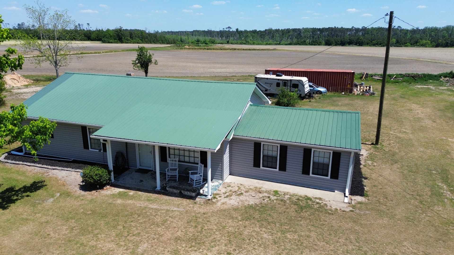 Faded green metal roof before coating restoration